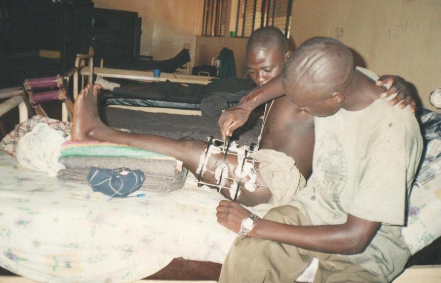 A wounded officer receiving care for a leg injury